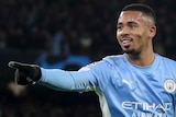 Manchester City player Gabriel Jesus points and smiles as he runs after scoring a goal Champions League goal against PSG.