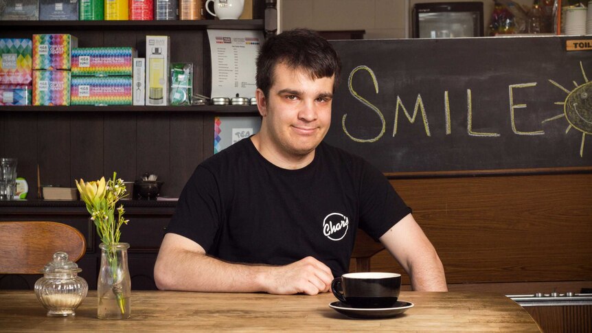 Chris Damceski sits at a table.