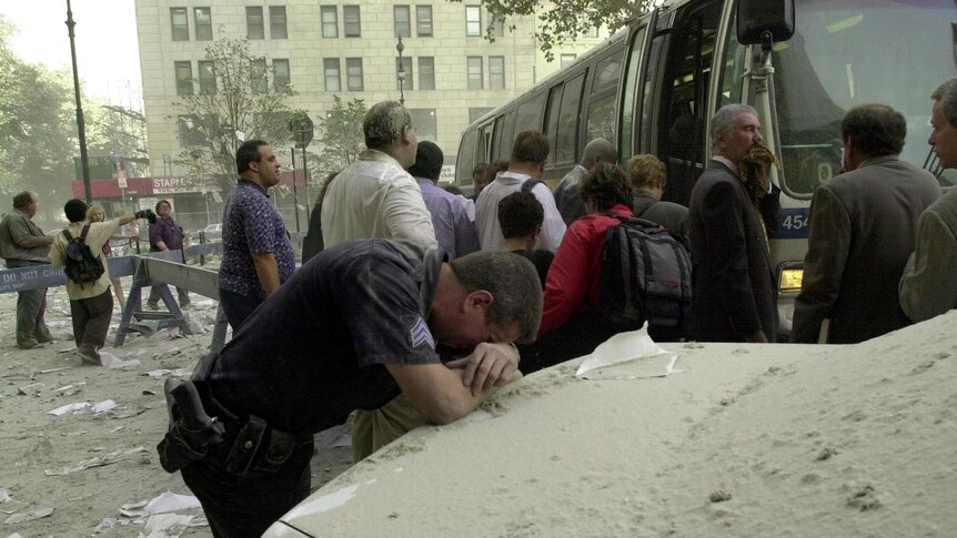 Exhausted police officer rests after the World Trade Centre towers collapsed