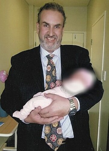Dr Brett Daniels pictured with unidentified baby.
