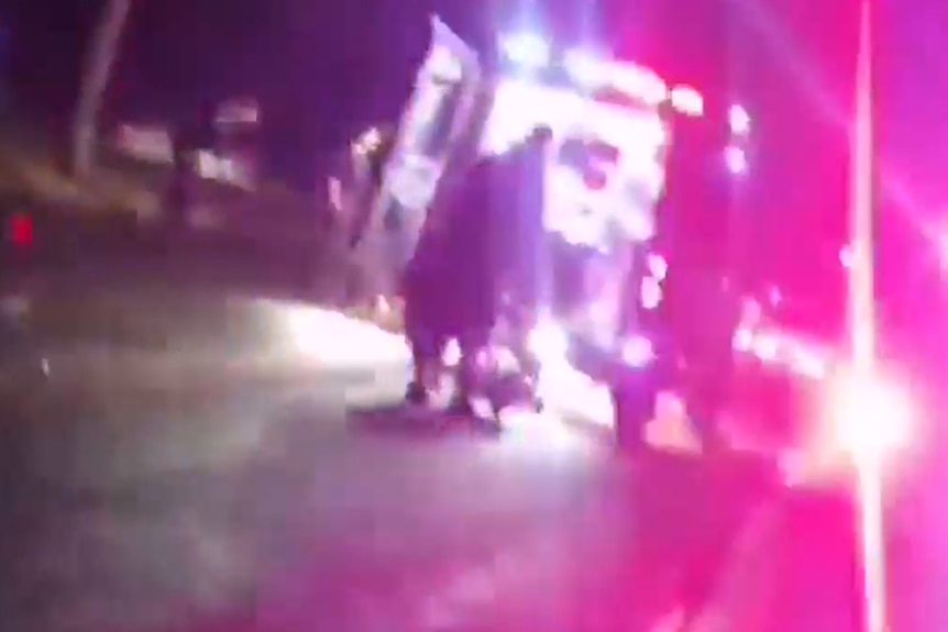 a video screen shot of an ambulance at night