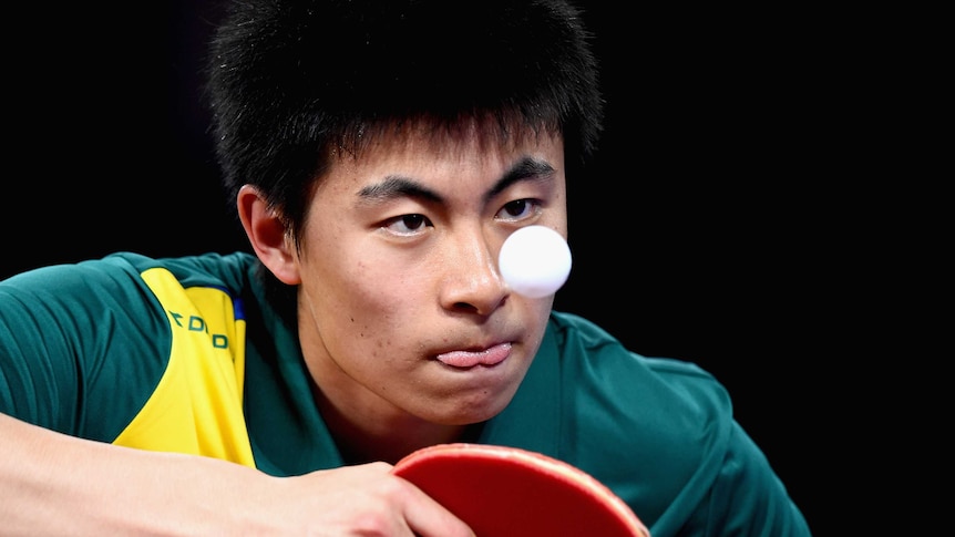 A close up photo of Australian table tennis player Heming Hu concentrating on the ball at the Glasgow 2014 Commonwealth Games.