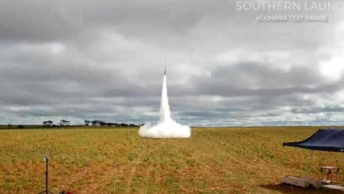 A rocket takes off from farmland