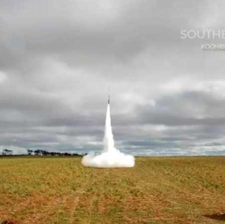 A rocket takes off from farmland