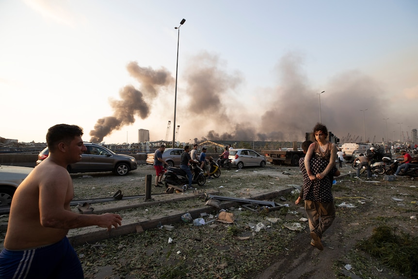 People evacuate wounded after of a massive explosion in Beirut, Lebanon