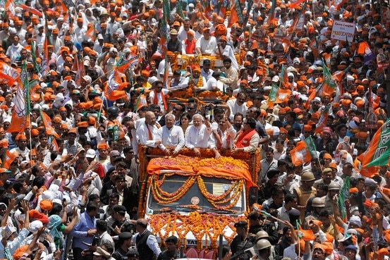 Narenda Modi flashes a victory sign to supporters as he arrives in Varanasi, India, in 2014.