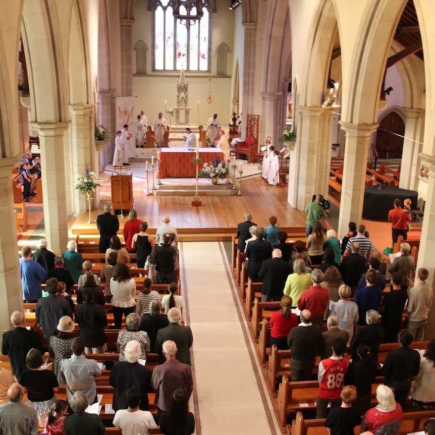 Worshippers attend a Catholic church service in Hobart