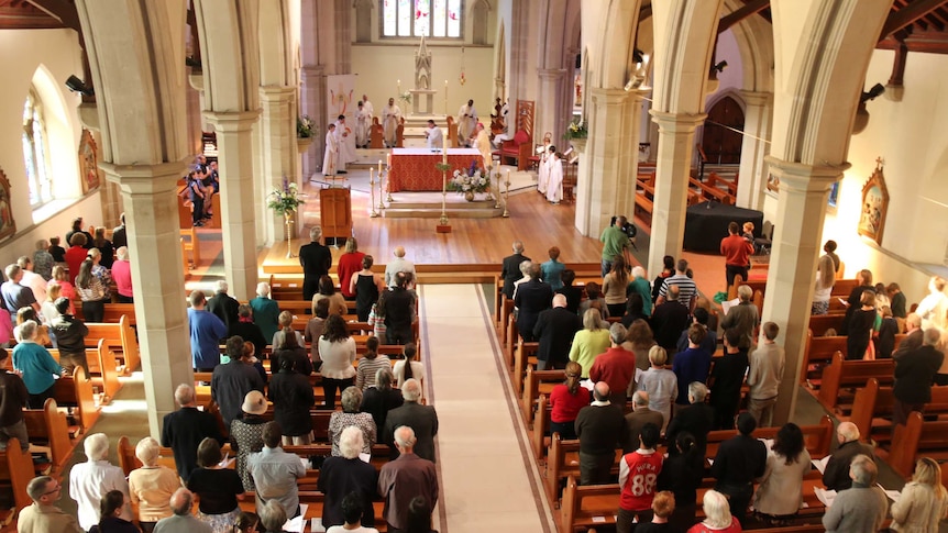 Worshippers attend a Catholic church service in Hobart