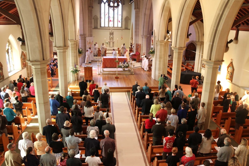 Worshippers attend a Catholic church service in Hobart