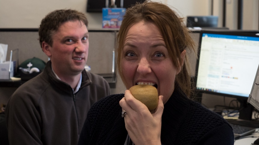 Ali Clarke bites into a kiwi fruit as producer Luke Franklin looks on in horror.
