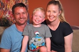 An image of Luke, Eli and Kiri Adamson in their home.