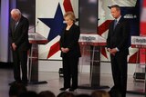 Democratic US presidential candidates bow their heads in a moment of silence for the victims of Paris attacks