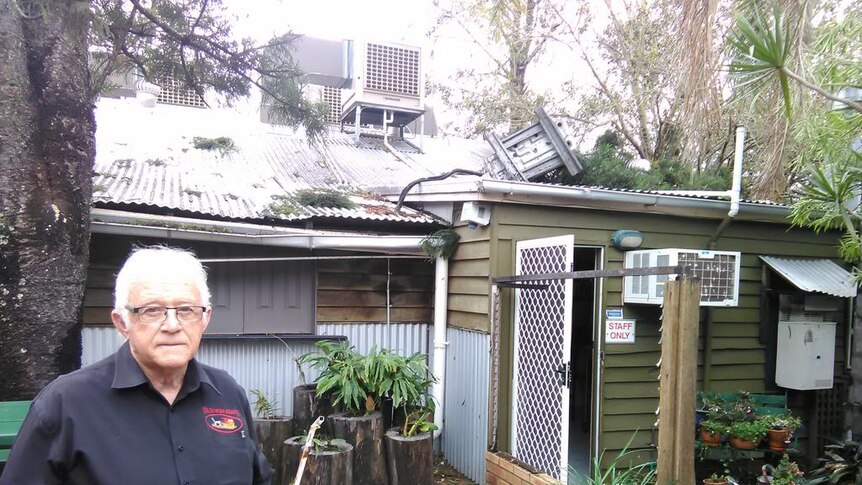 Bill Rose inspects the damage following a wild storm