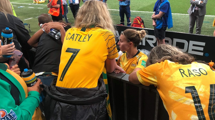 Matildas player Steph Catley talks to family at the ground after a match. Her mum is wearing a top with their name on it.