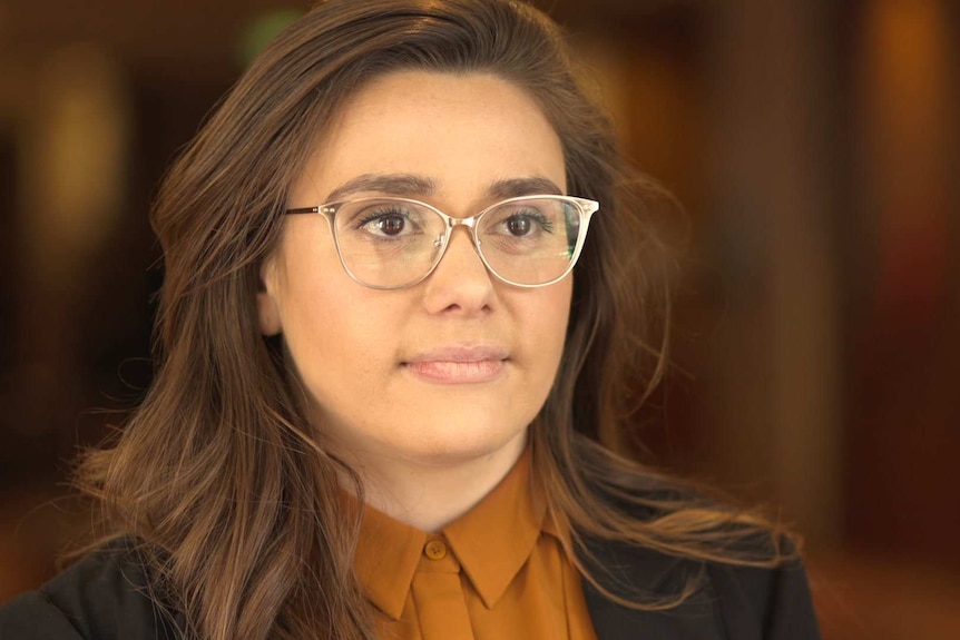 Head shot of Eliza Owen, property researcher at Domain, with blurred background