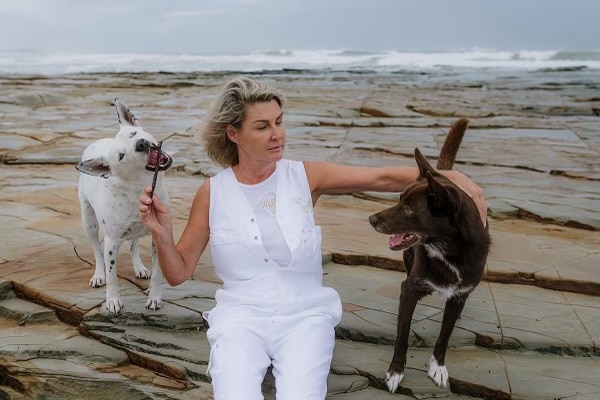 Lady on beach with two dogs
