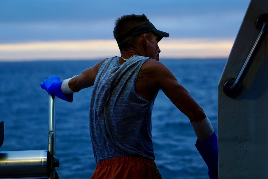 Man staring out to horizon on a lobster boat