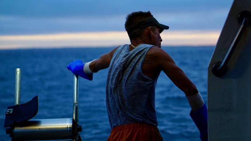 Man staring out to horizon on a lobster boat