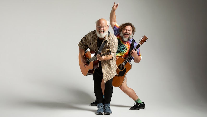 Jack Black and Kyle Gass of Tenacious D play guitars. Black holds up the devil horns sign with his fingers.