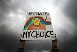 A woman holds a placard saying "My hair my choice" during a protest against the death of Iranian Mahsa Amini, in Berlin.