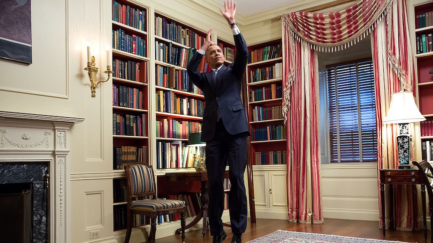 President Barack Obama feigns a jump shot