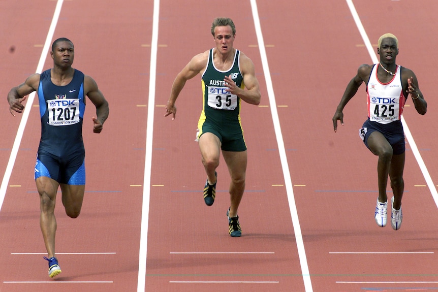 Bernard Williams, Matthew Shirvington and Christian Malcolm sprinting on a running track