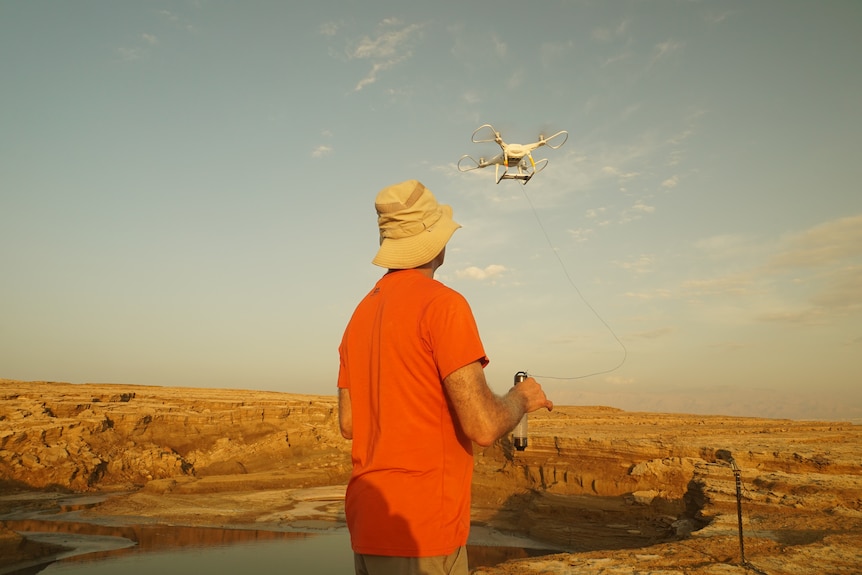 A man flies a drone.