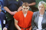 Nikolas Cruz appears via video monitor at a bond court hearing after being charged with 17 counts of premeditated murder.