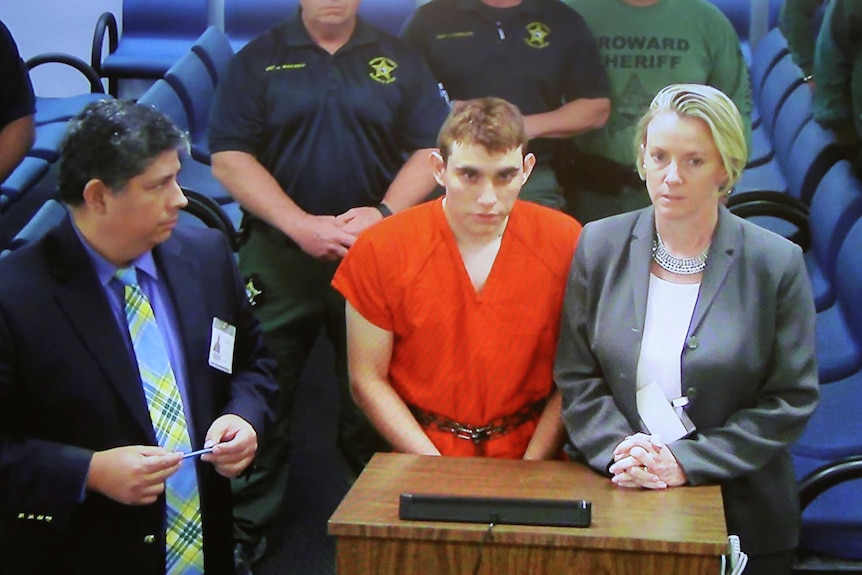 Nikolas Cruz appears via video monitor at a bond court hearing after being charged with 17 counts of premeditated murder.