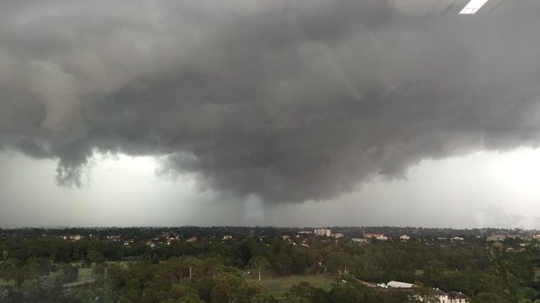 Dark grey rain clouds rolling in over Parramatta.