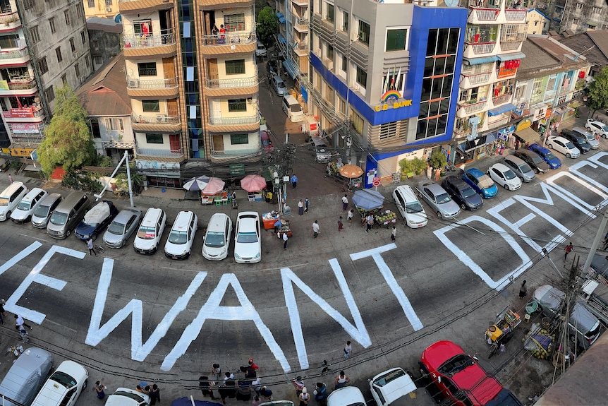 A 'we want democracy' slogan written on a street in Myanmar. 