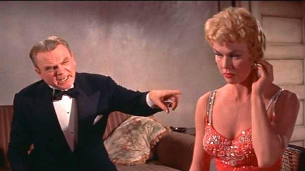 James Cagney shouts at Doris Day on screen as she turns away.