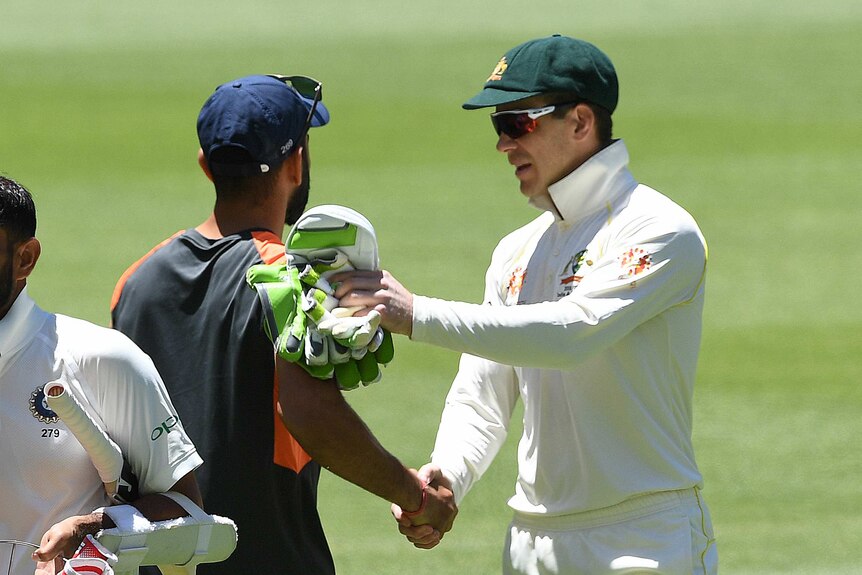 Australia cricket captain Tim Paine and India cricket captain Virat Kohli shake hands on the field after a Test match.