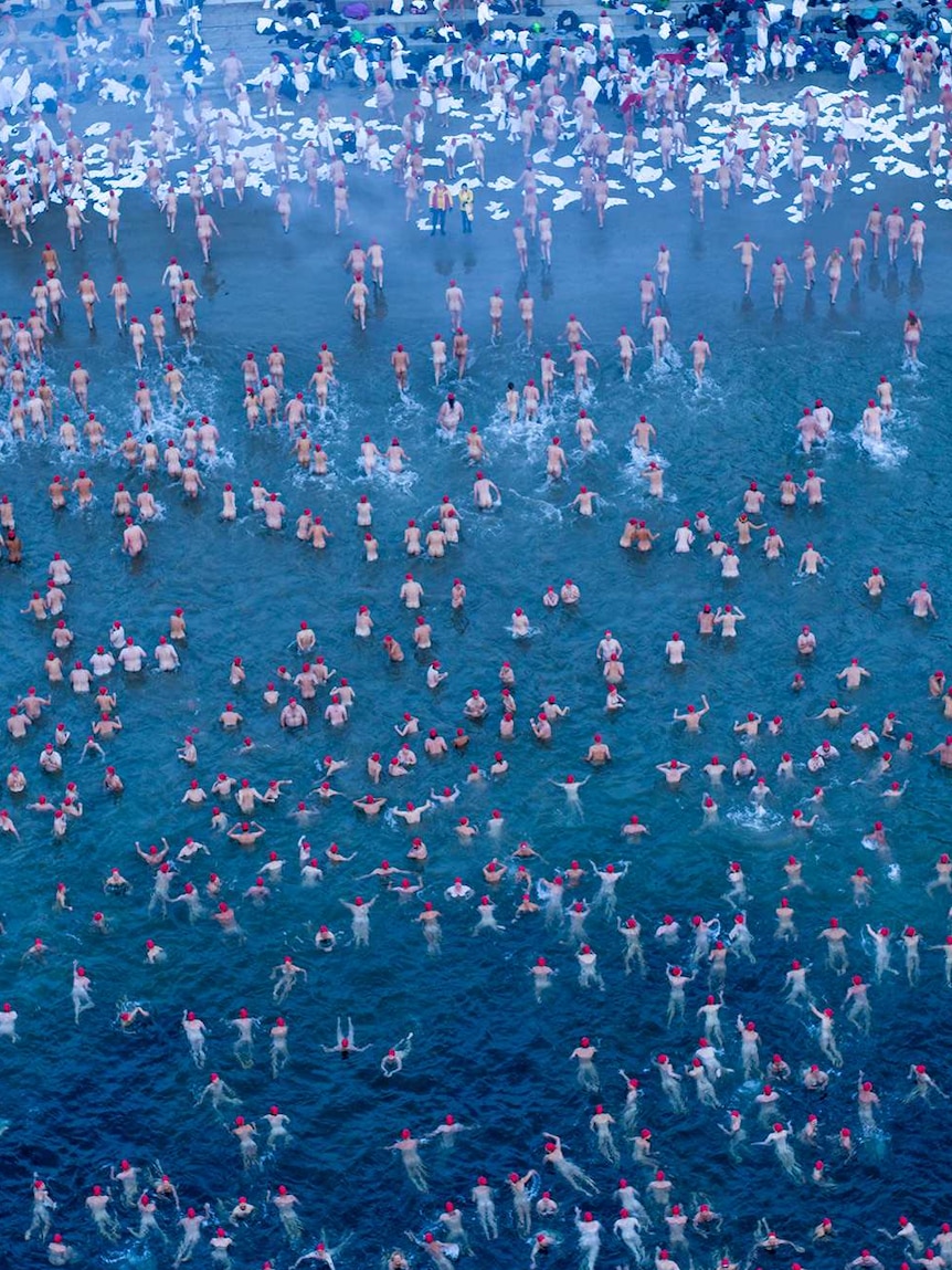 Aerial view of swimmers leaving the water after Dark Mofo nude swim, 2018.