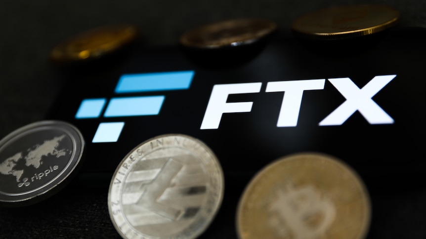 FTX logo displayed on a phone screen and representation of cryptocurrency coins.