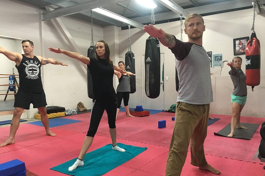 Group of military veterans and family in Brisbane suffering PTSD turn to yoga ease their minds