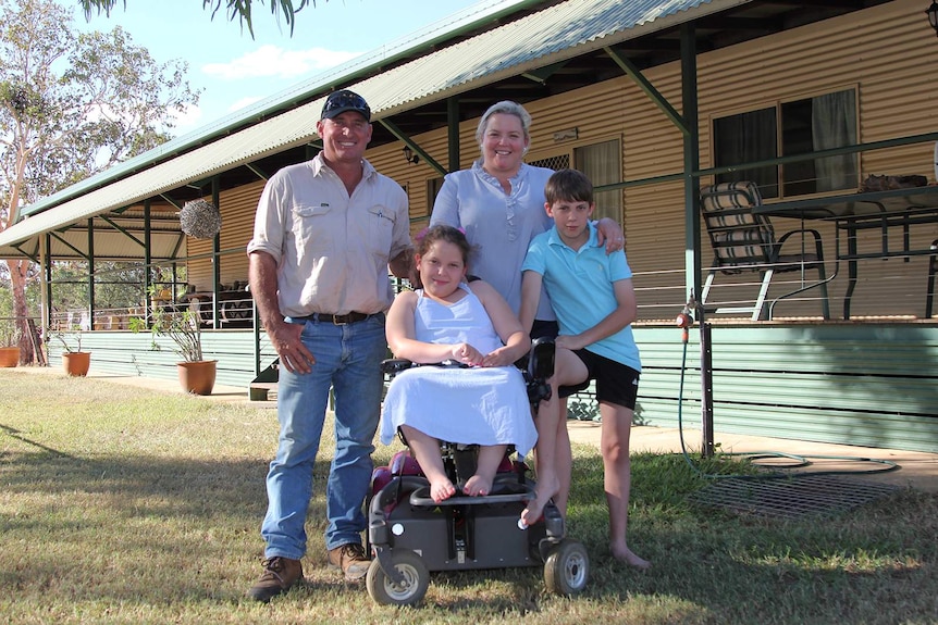 A family portrait of the Brown family in Katherine, standing out the front of their large rural house.