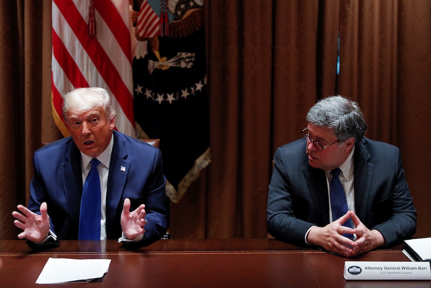 US former president Donald Trump speaks to former AG William Barr in 2020.