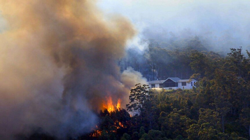 A bushfire threatens a house at Geeveston.