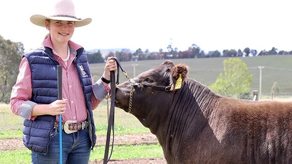 Kirrilee Scott holding the Champion Steer.