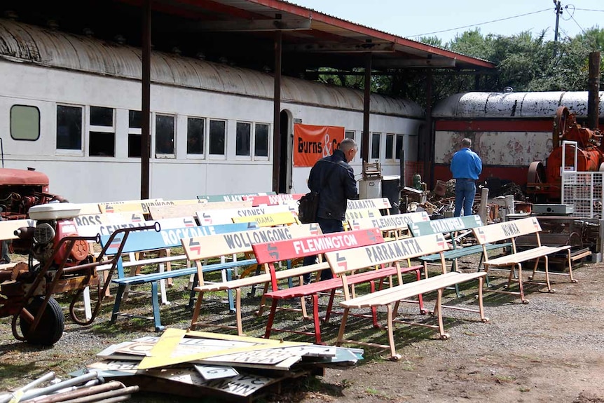 Old fashioned wooden railway seats lined up in a row.