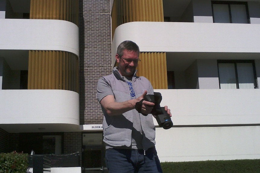 Man holds large camera