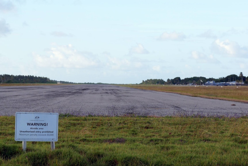 The northern end of the Cocos Island runway with a sign warning about unauthorised access.
