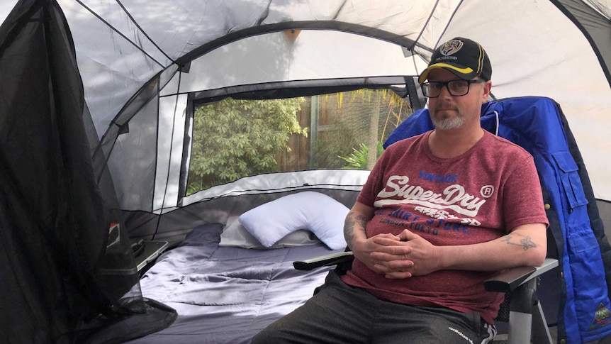 A man living in a tent.