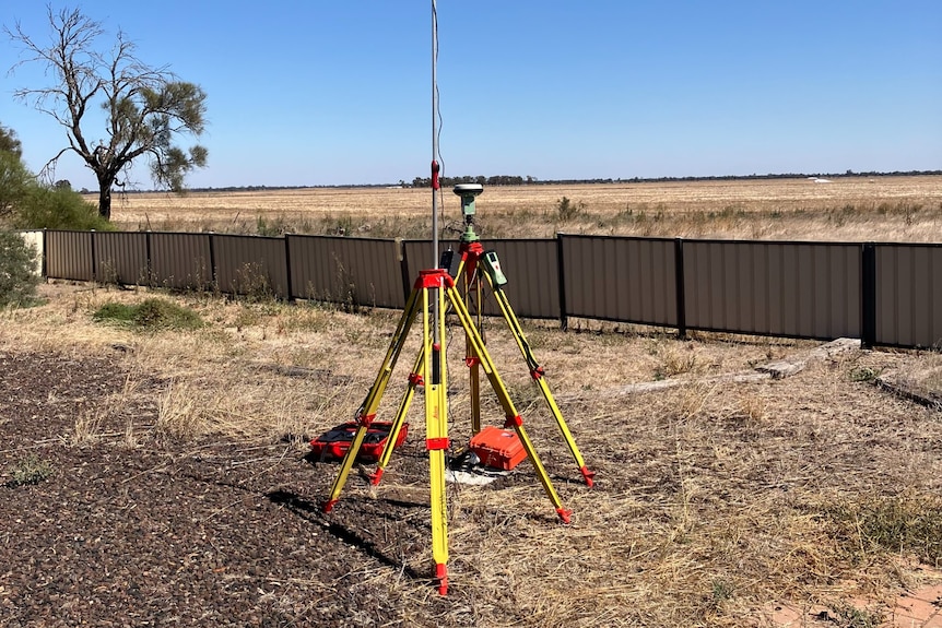 Some survey equipment on a flat, dry stretch of land.
