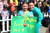 Anna Meares poses with a young fan