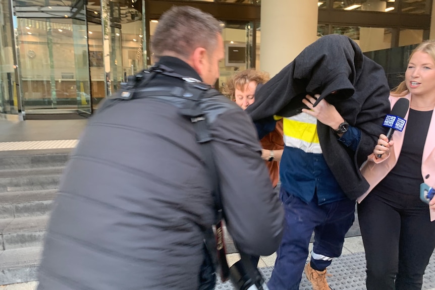 Mr McConnaughty covered his face and members of his family clashed with the media as he left court.