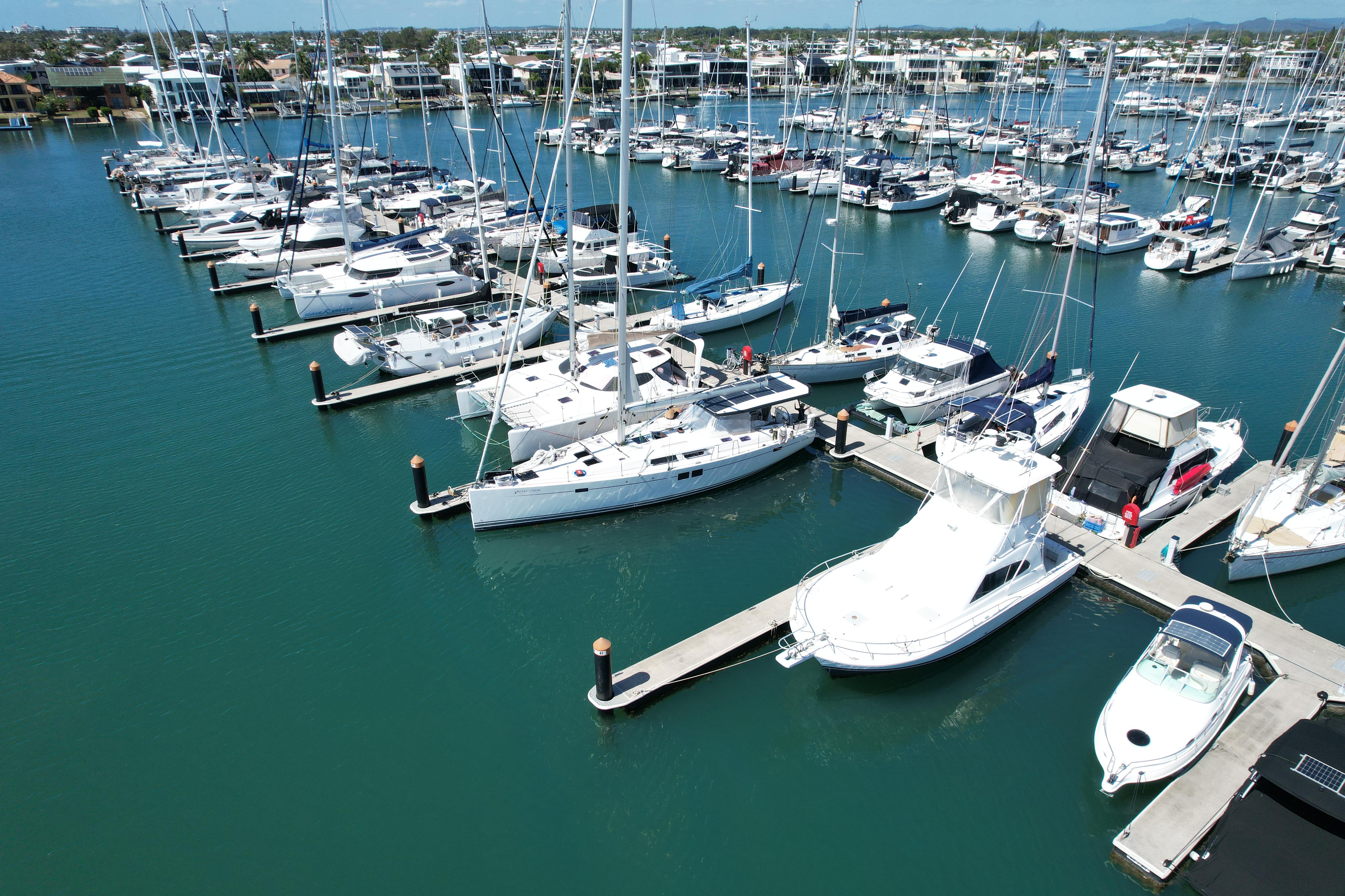 drone photograph taken above a marina of yachts on turquoise water