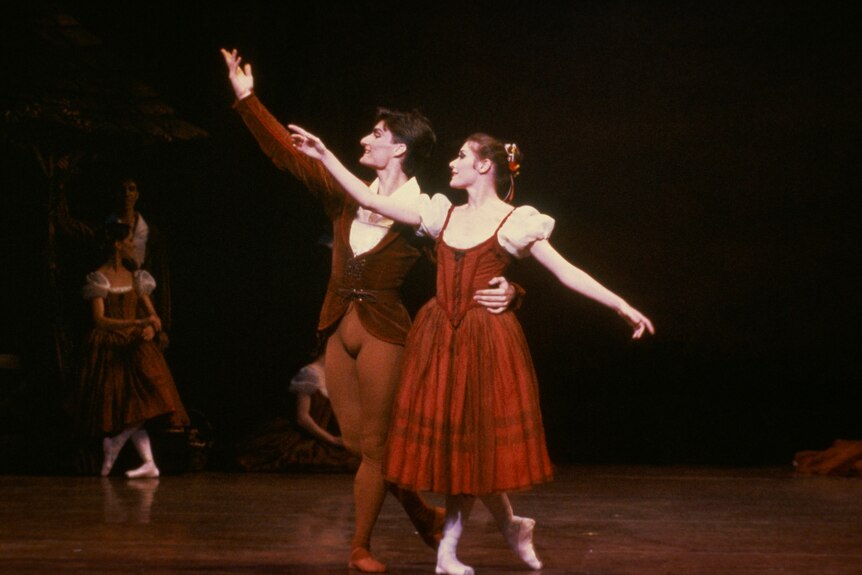 A male and female ballet dancer performing Giselle on stage