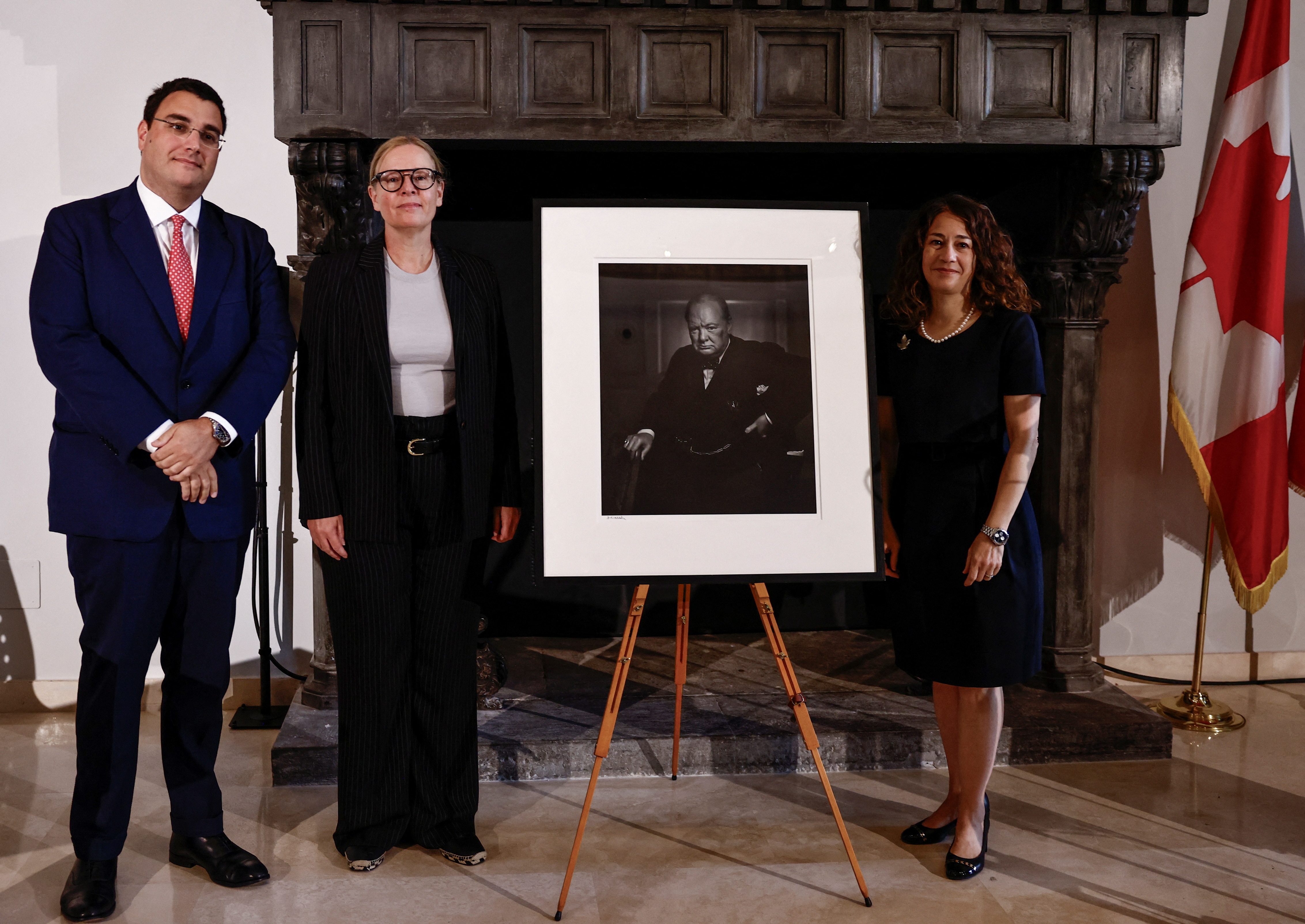 A group is around a portrait of Winston Churchill